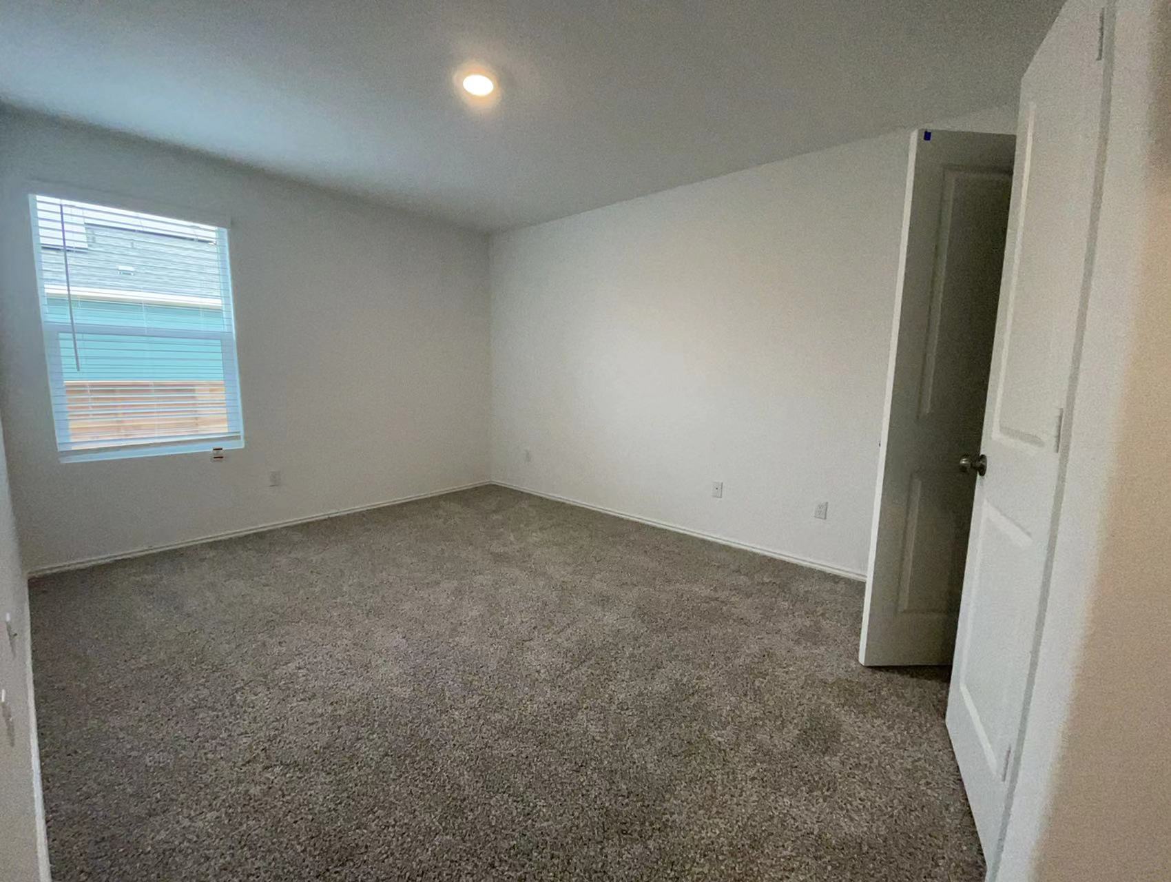 125 Madrid Kyle, TX 78640 - Photo 15 of 23 Carpeted spare room with baseboards