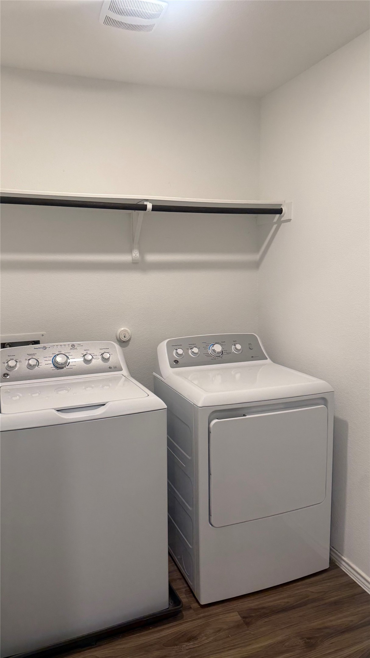 125 Madrid Kyle, TX 78640 - Photo 16 of 23 Laundry room featuring dark wood finished floors and washer and dryer