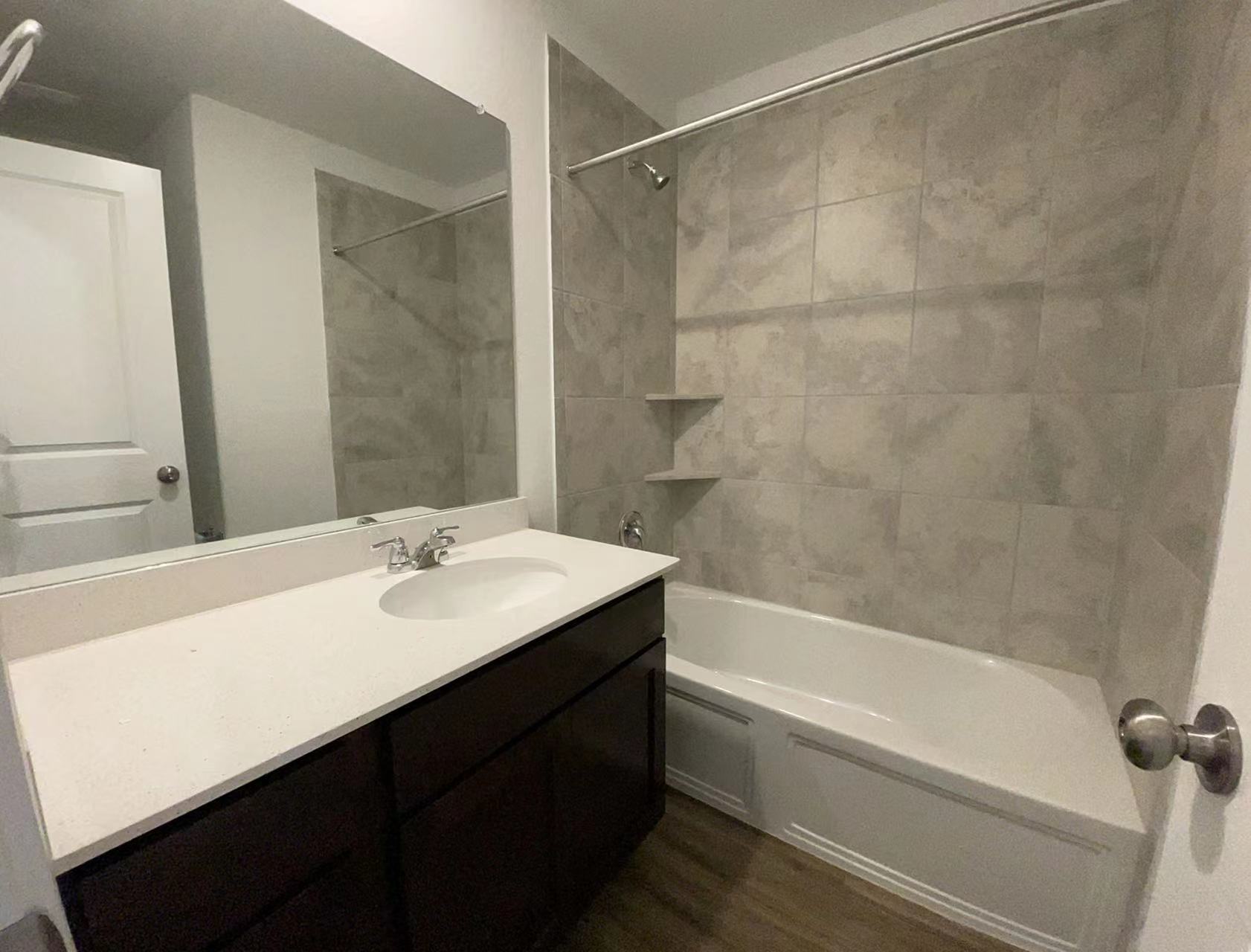 125 Madrid Kyle, TX 78640 - Photo 17 of 23 Full bath featuring vanity, bathtub / shower combination, and dark wood-type flooring
