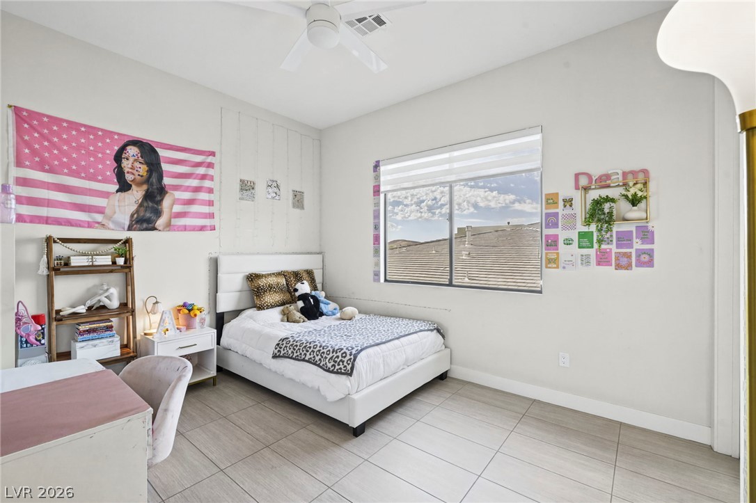 4208 Lapis Ridge Court Las Vegas, NV 89135 - Photo 30 of 61 High ceilings and neutral tile flooring create a spacious and modern foundation in this bedroom.