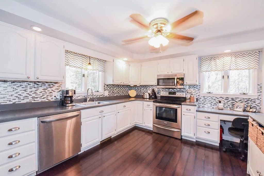 4 Nehemiah Road Shirley, MA 01464 - Photo 2 of 25 a kitchen with granite countertop white cabinets and white appliances