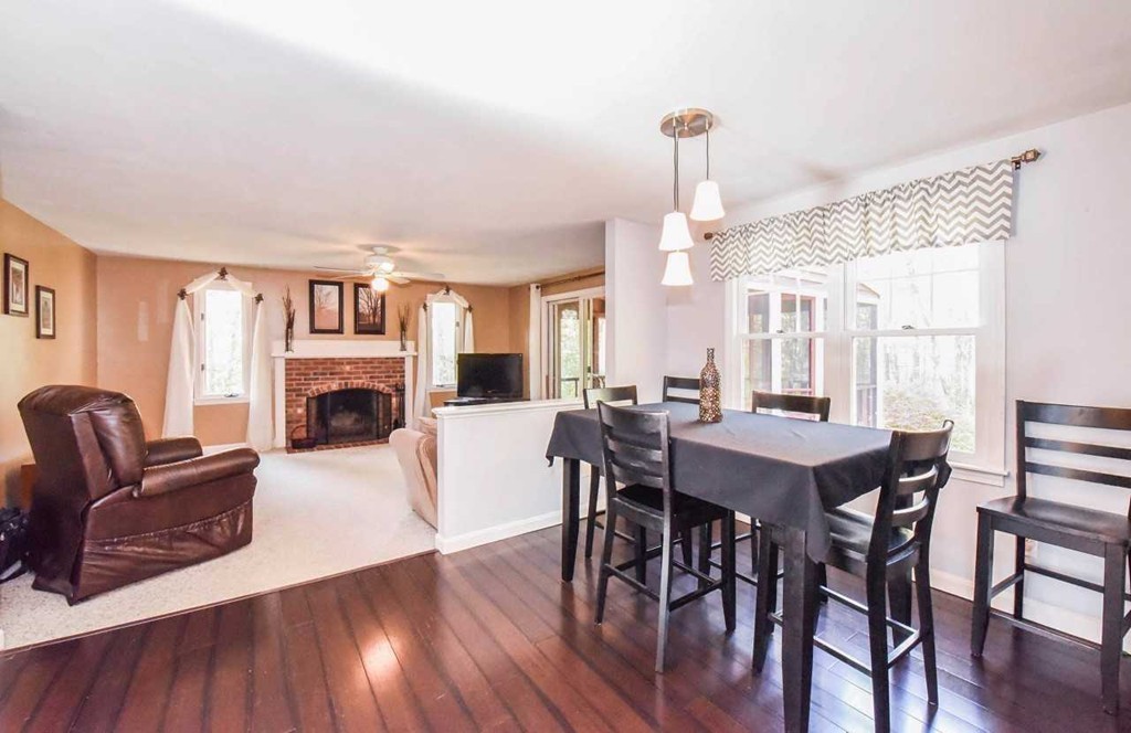 4 Nehemiah Road Shirley, MA 01464 - Photo 4 of 25 a living room with furniture a fireplace and a dining table with wooden floor