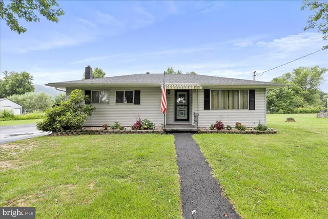 a front view of house with yard and outdoor seating