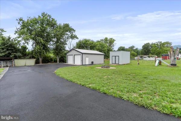a view of an house with backyard space and garden