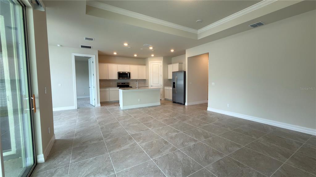 1523 Groveline Road St. Cloud, FL 34771 - Photo 11 of 30 a view of a kitchen with a sink and a refrigerator
