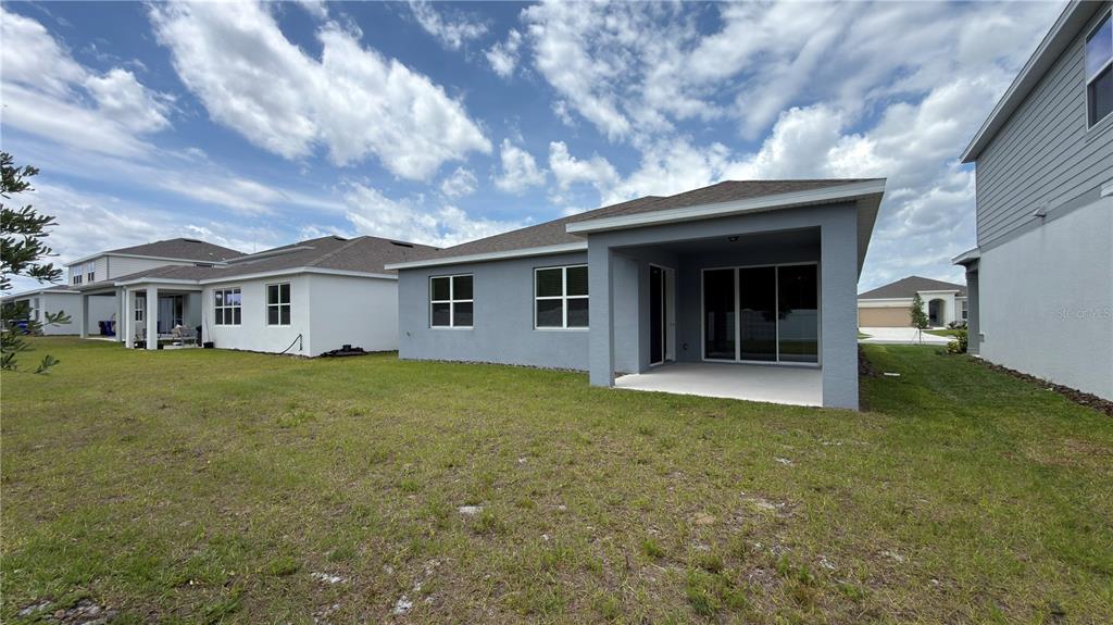 1523 Groveline Road St. Cloud, FL 34771 - Photo 25 of 30 a view of a house with a backyard