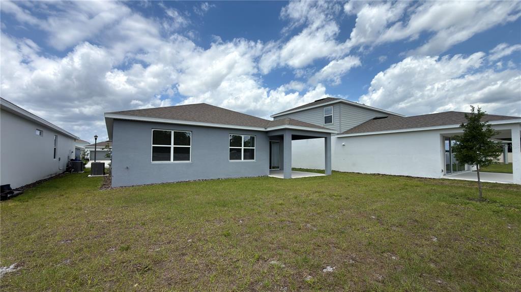 1523 Groveline Road St. Cloud, FL 34771 - Photo 26 of 30 a view of a house with a yard and garage