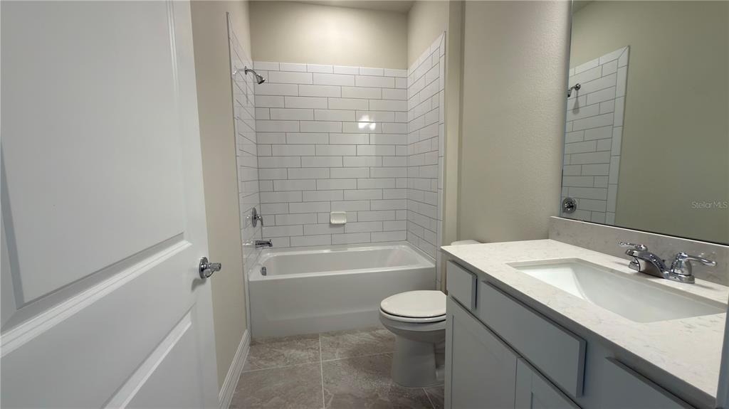 1523 Groveline Road St. Cloud, FL 34771 - Photo 7 of 30 a bathroom with a sink toilet vanity and bathtub