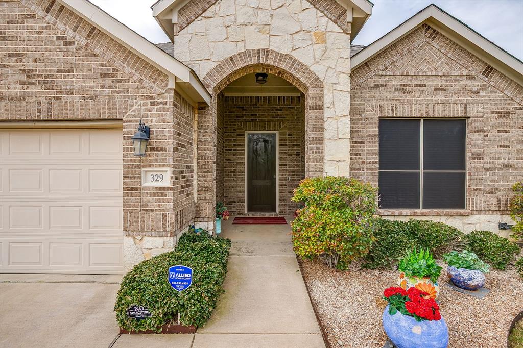 329 Madison Street Burleson, TX 76028 - Photo 1 of 40 a front view of a house with plants