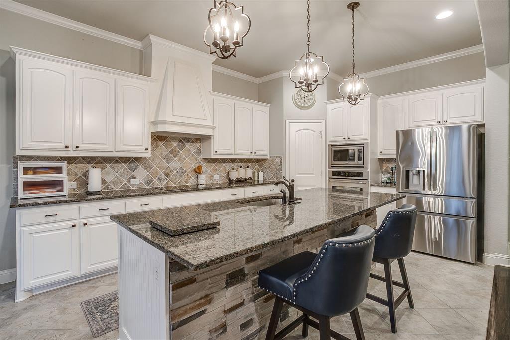 329 Madison Street Burleson, TX 76028 - Photo 12 of 40 a kitchen with stainless steel appliances granite countertop a sink a stove a refrigerator and island