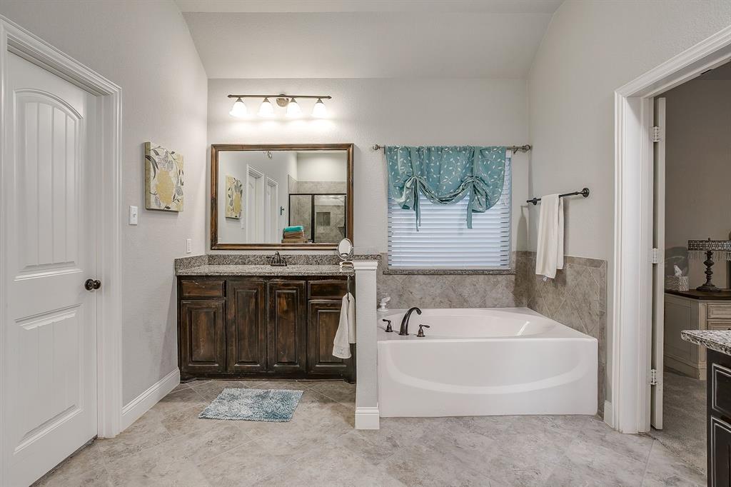 329 Madison Street Burleson, TX 76028 - Photo 20 of 40 a spacious bathroom with a tub sink and mirror