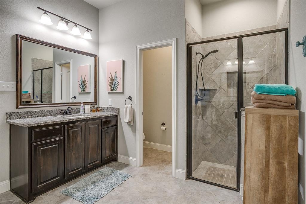 329 Madison Street Burleson, TX 76028 - Photo 21 of 40 a bathroom with a double vanity sink mirror and shower