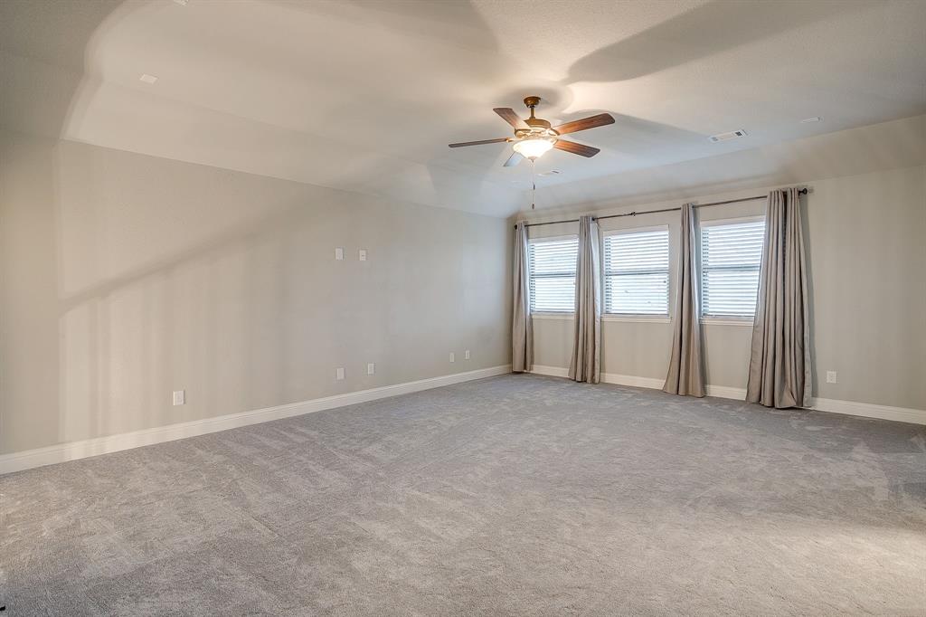 329 Madison Street Burleson, TX 76028 - Photo 23 of 40 a view of an empty room with chandelier fan and a window