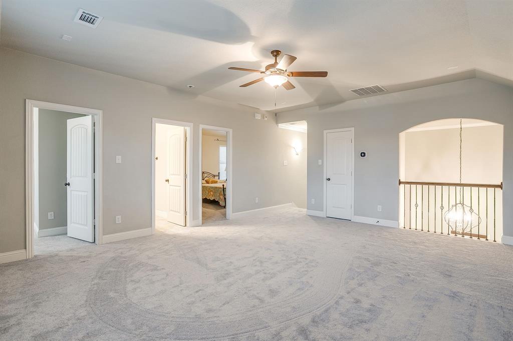 329 Madison Street Burleson, TX 76028 - Photo 24 of 40 an empty room with chandelier fan and windows