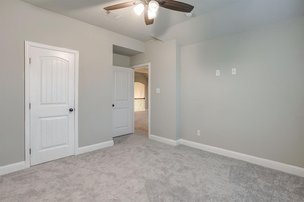 329 Madison Street Burleson, TX 76028 - Photo 26 of 40 a view of an empty room with a chandelier fan