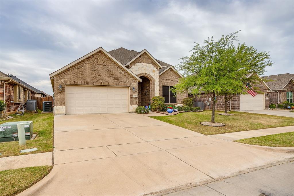 329 Madison Street Burleson, TX 76028 - Photo 3 of 40 a front view of a house with garden