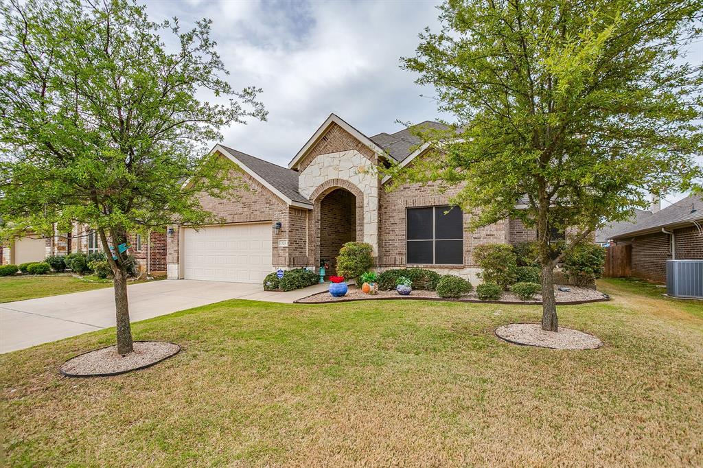329 Madison Street Burleson, TX 76028 - Photo 4 of 40 a front view of a house with a yard and trees