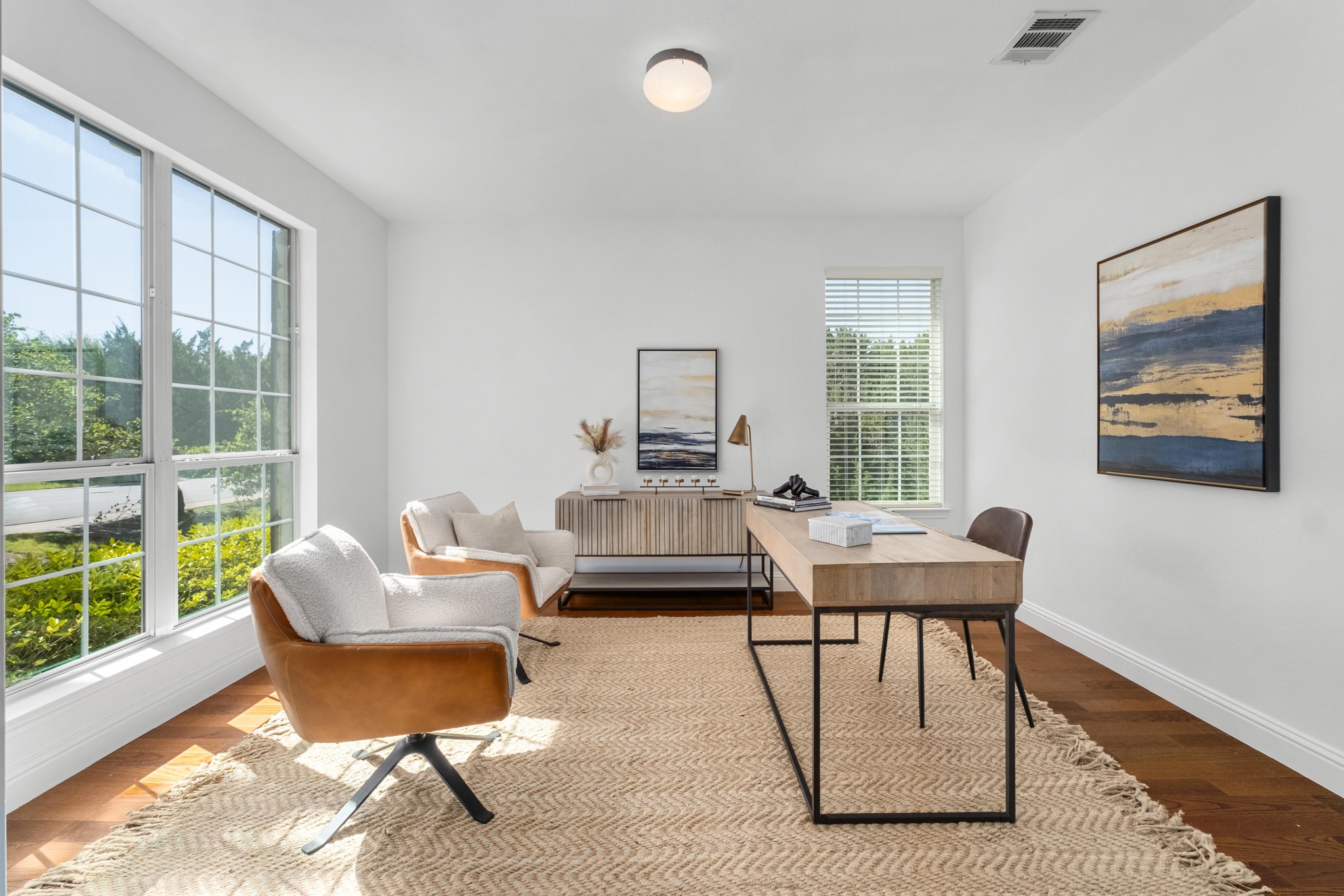 16200 Spillman Ranch Loop Austin, TX 78738 - Photo 10 of 36 Natural light floods this versatile home office, boasting elegant hardwood flooring and ample workspace.