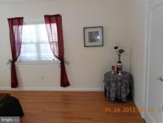 3203 Gunston Road, Unit 11032 Alexandria, VA 22302 - Photo 12 of 20 a room with window and a wooden floor