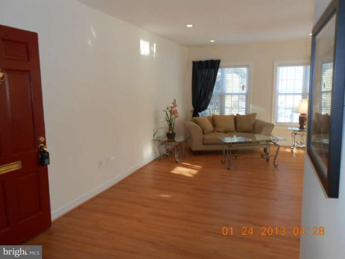 3203 Gunston Road, Unit 11032 Alexandria, VA 22302 - Photo 15 of 20 a living room with furniture and a flat screen tv