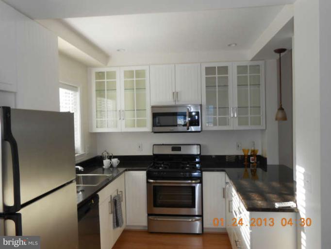 3203 Gunston Road, Unit 11032 Alexandria, VA 22302 - Photo 18 of 20 a kitchen with stainless steel appliances granite countertop a stove and a refrigerator