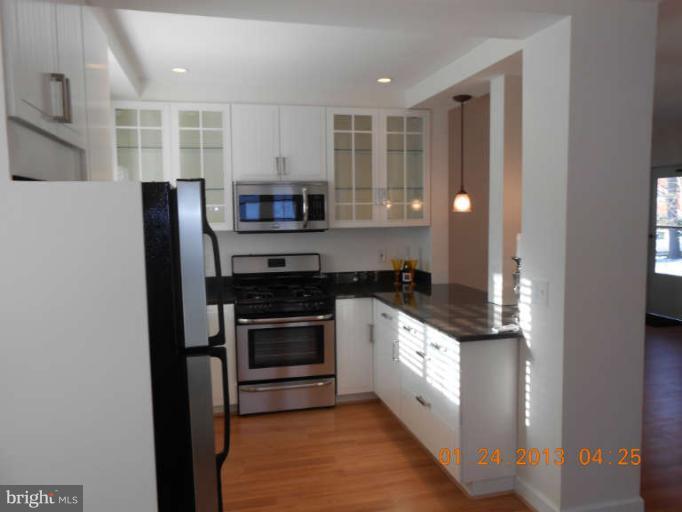 3203 Gunston Road, Unit 11032 Alexandria, VA 22302 - Photo 5 of 20 a kitchen with stainless steel appliances granite countertop a stove and a refrigerator