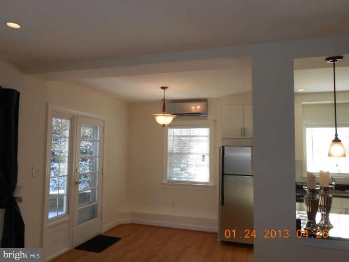 3203 Gunston Road, Unit 11032 Alexandria, VA 22302 - Photo 6 of 20 a kitchen with kitchen island a counter top space and a window