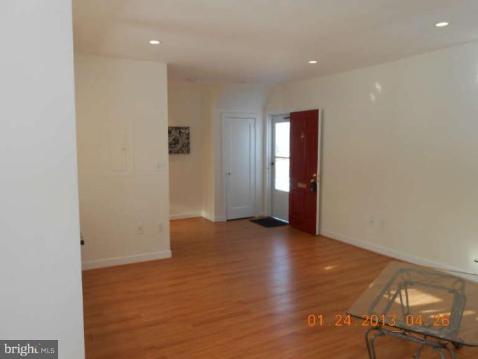 3203 Gunston Road, Unit 11032 Alexandria, VA 22302 - Photo 7 of 20 an empty room with wooden floor and windows