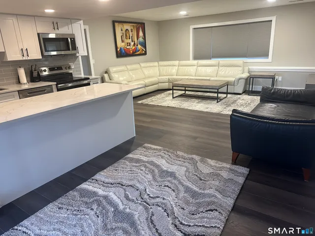 a spacious bathroom with a sink a mirror and bathtub