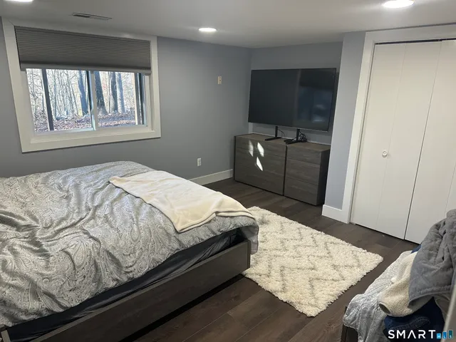 a bed sitting in a bedroom next to a window