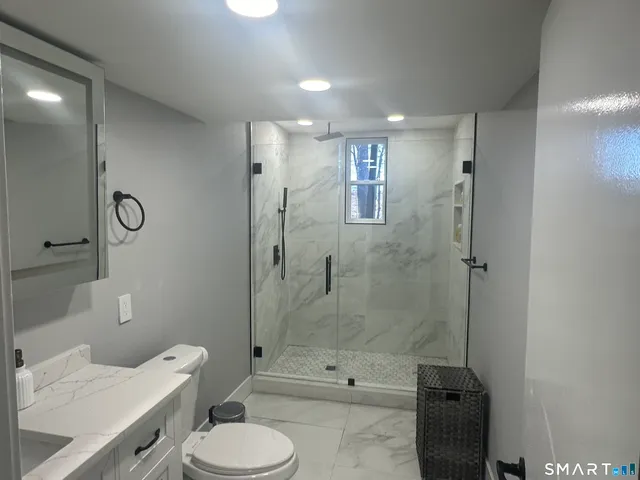 a bathroom with a sink toilet and shower