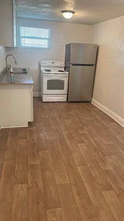 a kitchen with a stove top oven and sink