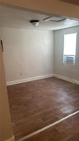 a view of a room with wooden floor