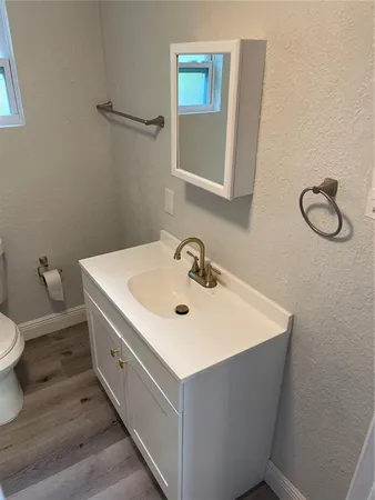 a bathroom with a sink toilet and mirror