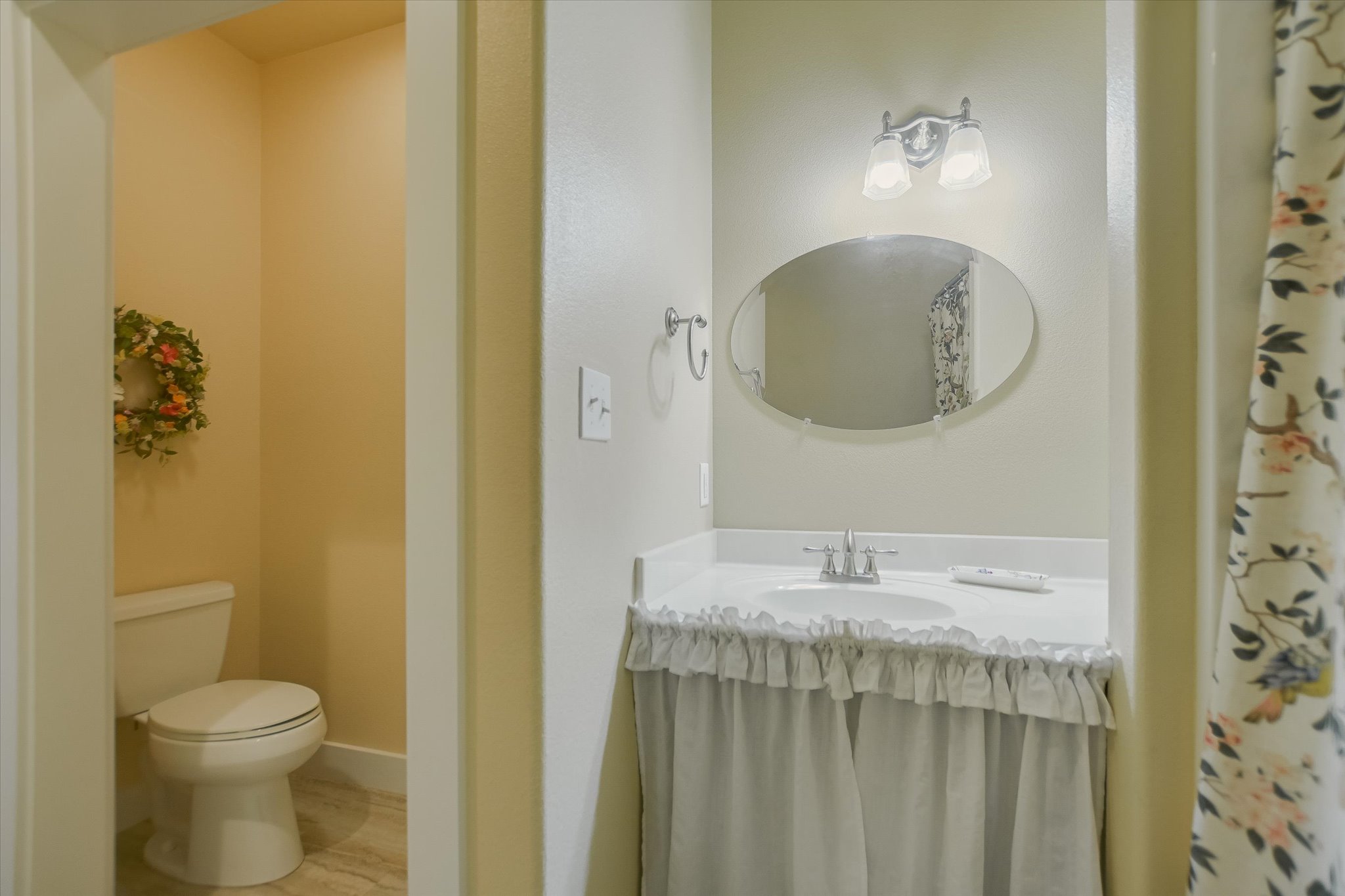 590 Rancho Grande Drive Wimberley, TX 78676 - Photo 23 of 30 a bathroom with a sink a toilet and mirror