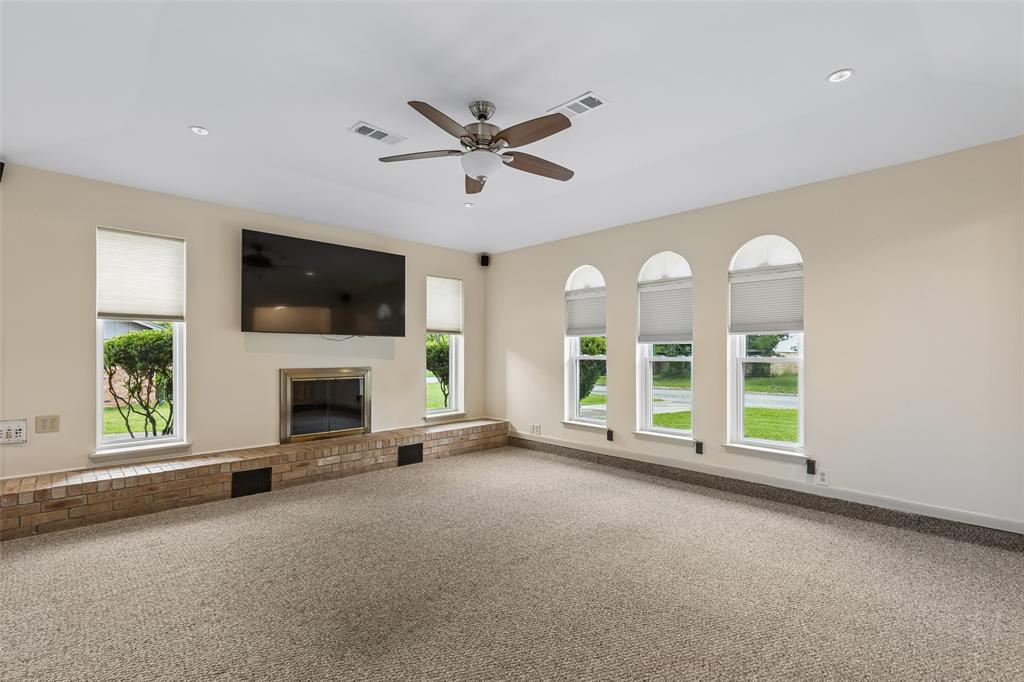 1548 Timbercreek Drive Howe, TX 75459 - Photo 5 of 24 a view of a livingroom with an empty space and a fireplace