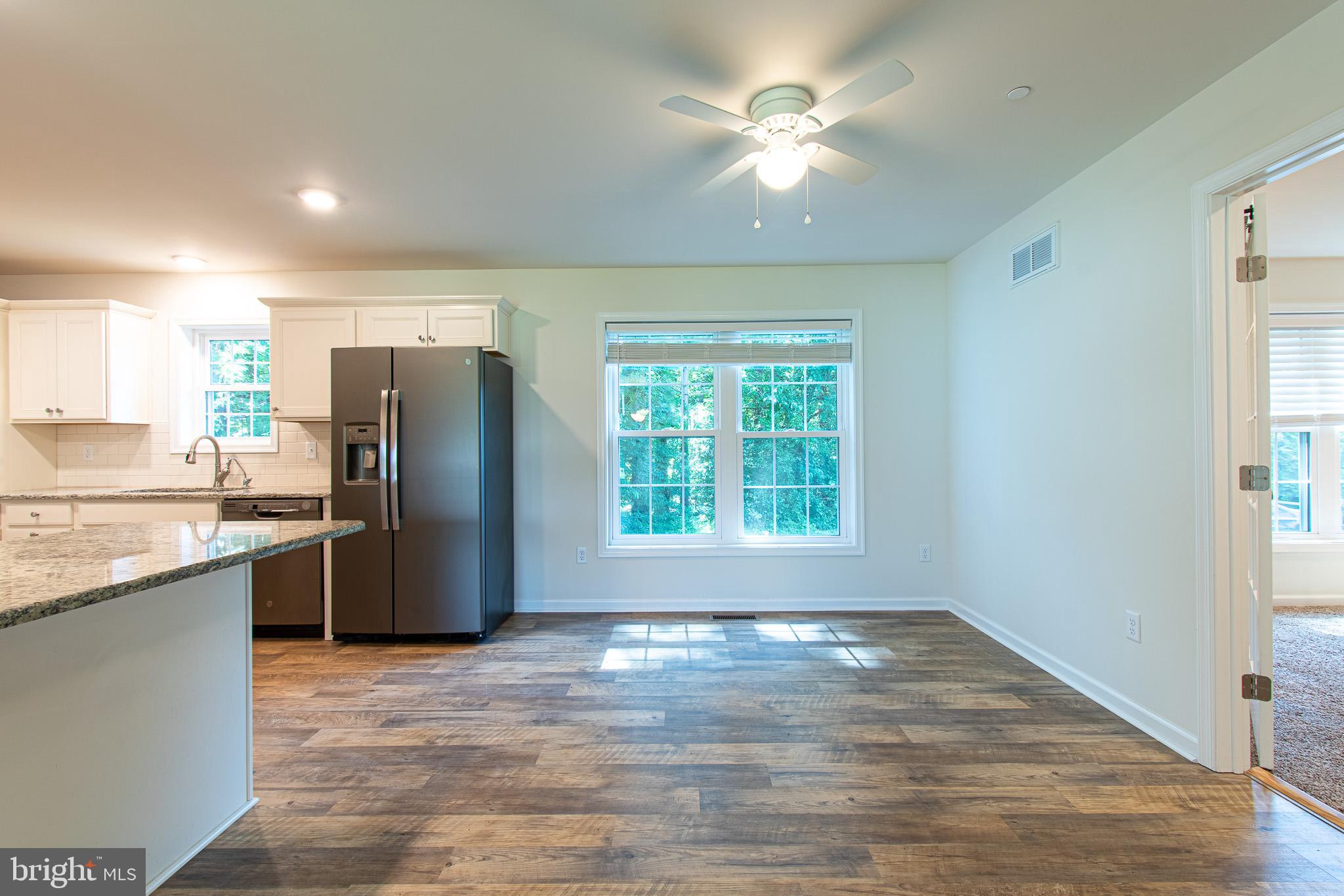 21869 Albie Road Sherwood, MD 21665 - Photo 11 of 38 a view of a kitchen with a stove cabinets and a ceiling fan
