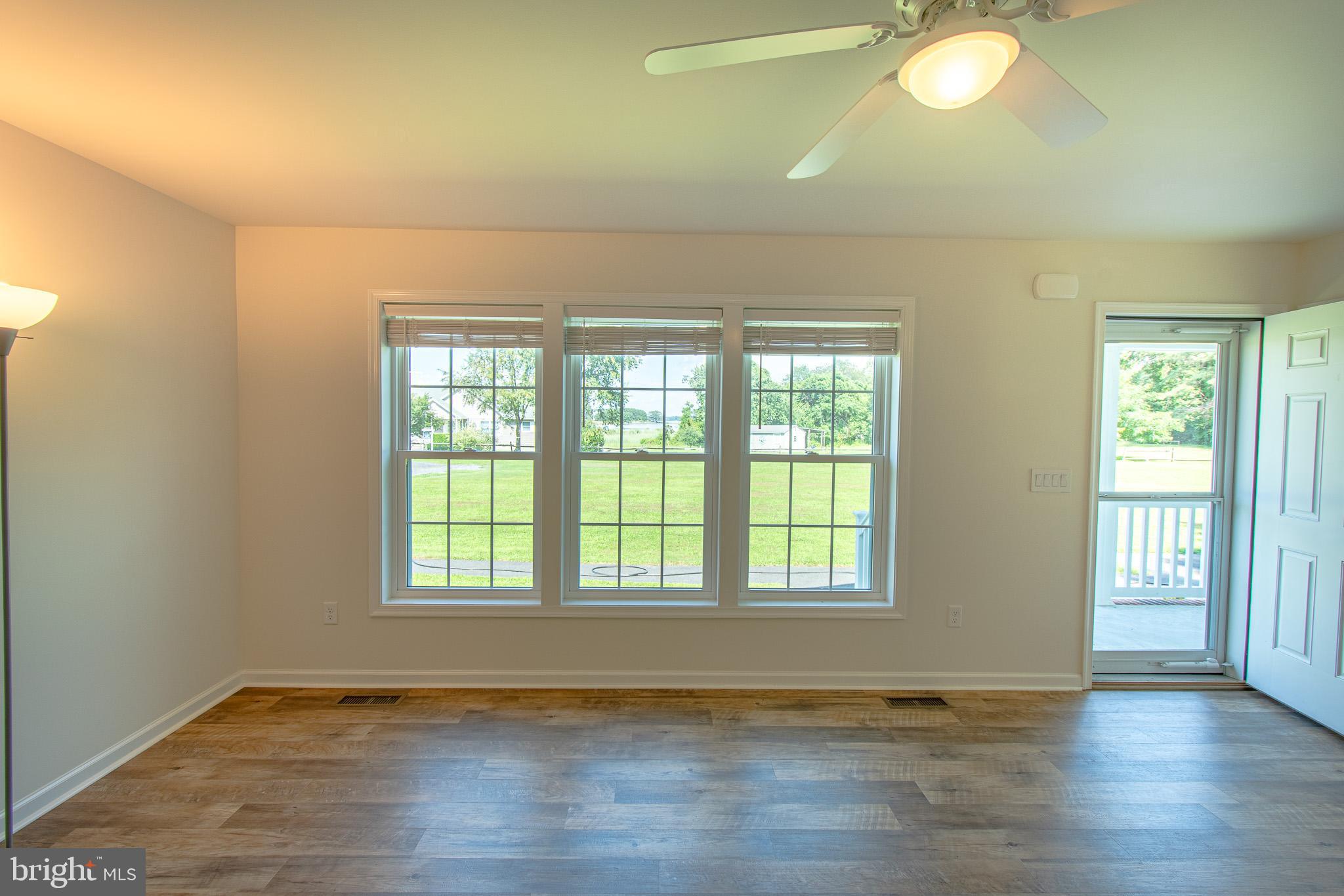 21869 Albie Road Sherwood, MD 21665 - Photo 16 of 38 a view of an empty room with wooden floor and a window