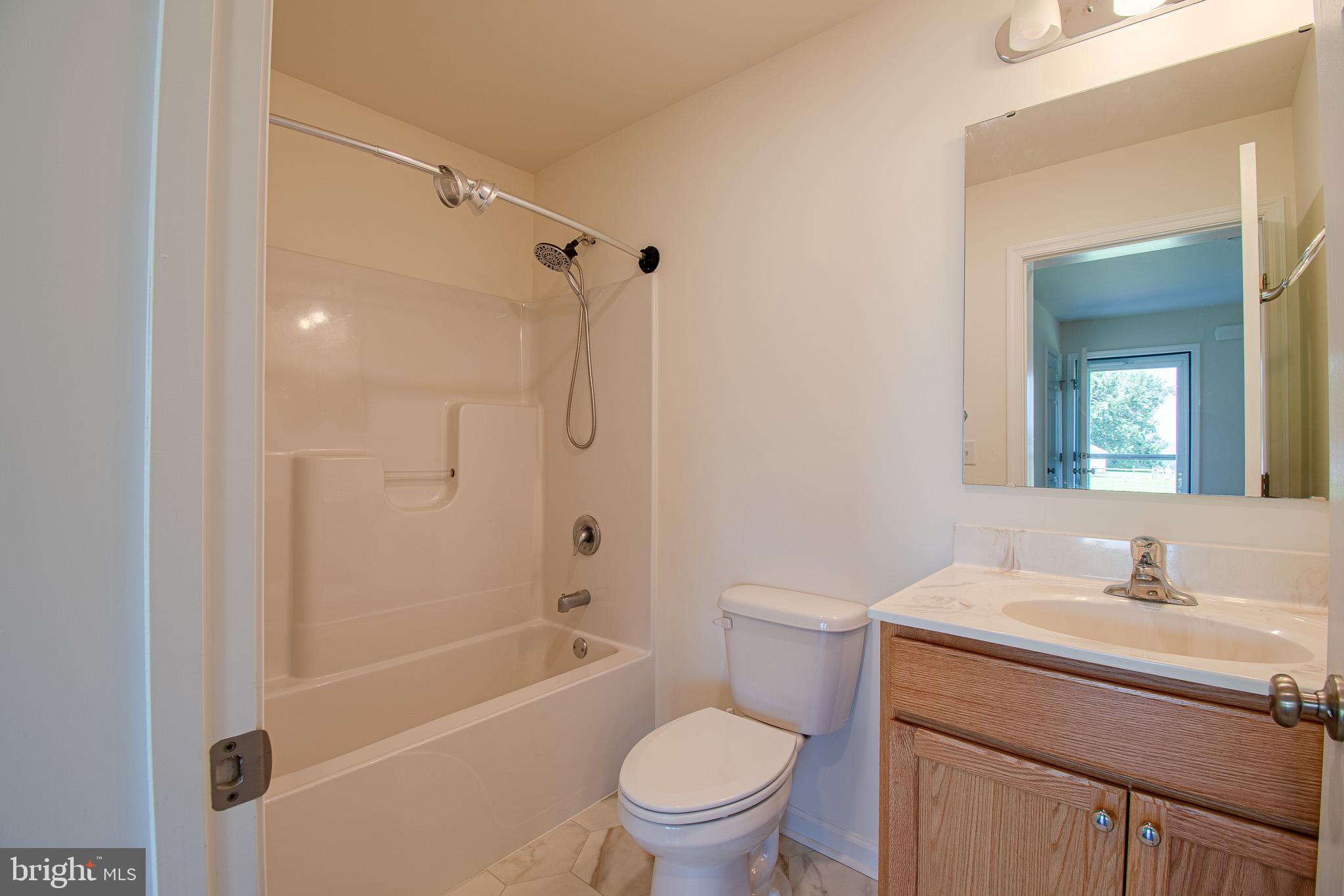 21869 Albie Road Sherwood, MD 21665 - Photo 18 of 38 a bathroom with a sink a toilet and a mirror