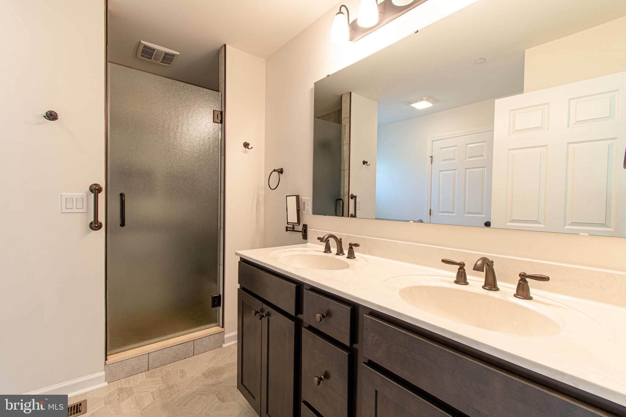 21869 Albie Road Sherwood, MD 21665 - Photo 21 of 38 a bathroom with a sink double vanity and a mirror
