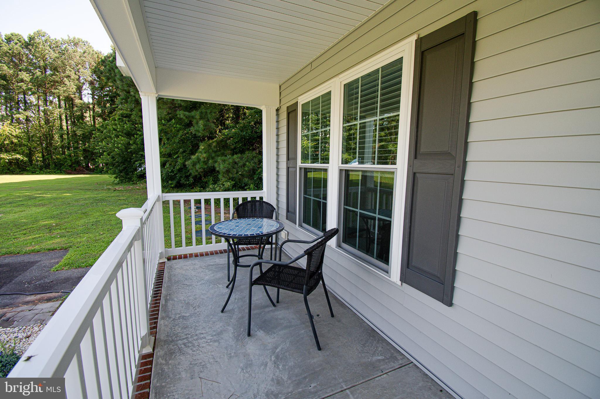 21869 Albie Road Sherwood, MD 21665 - Photo 3 of 38 a view of a deck with a table and chairs next to a yard
