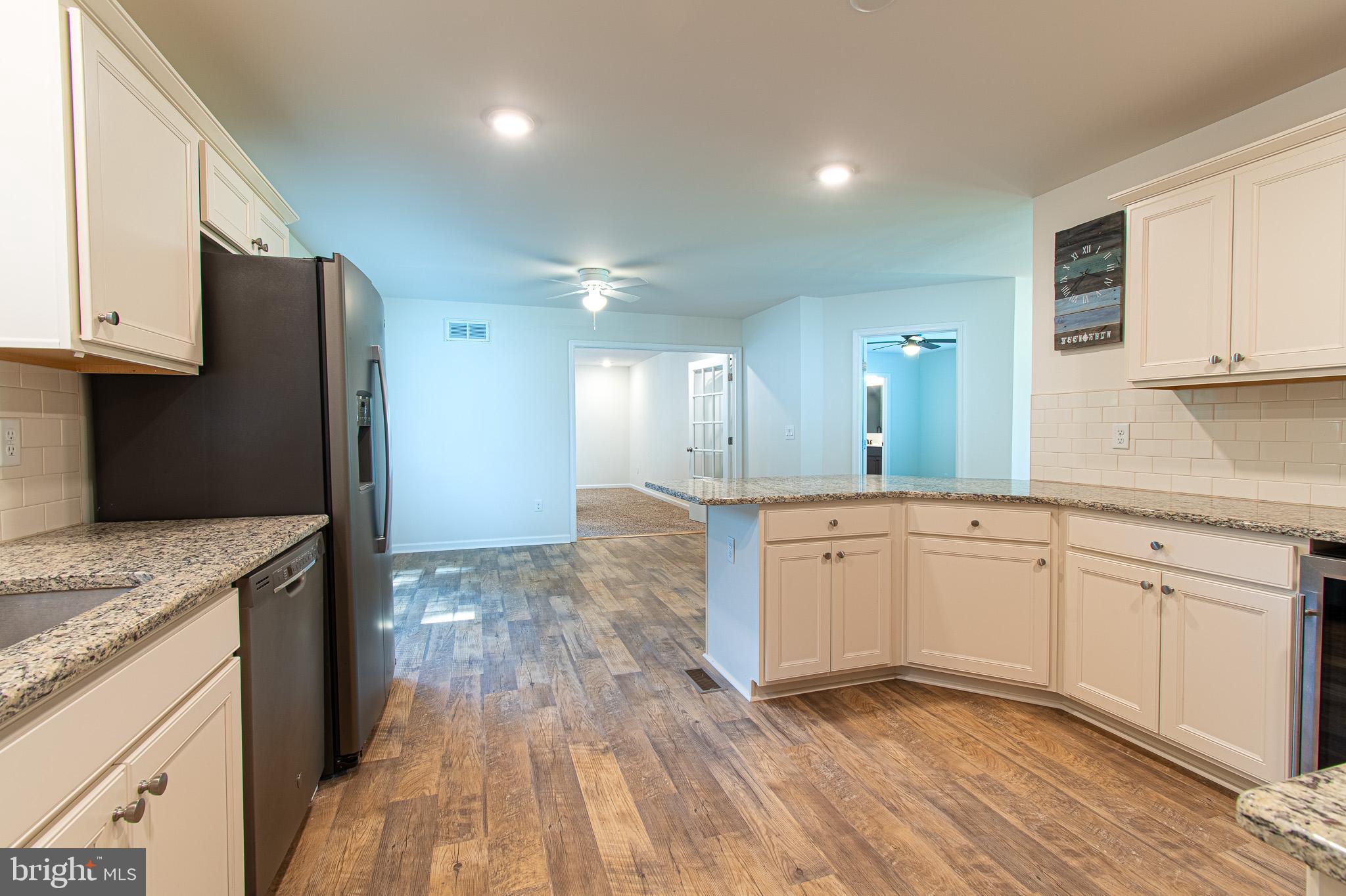 21869 Albie Road Sherwood, MD 21665 - Photo 9 of 38 a kitchen with granite countertop cabinets stainless steel appliances and a counter space
