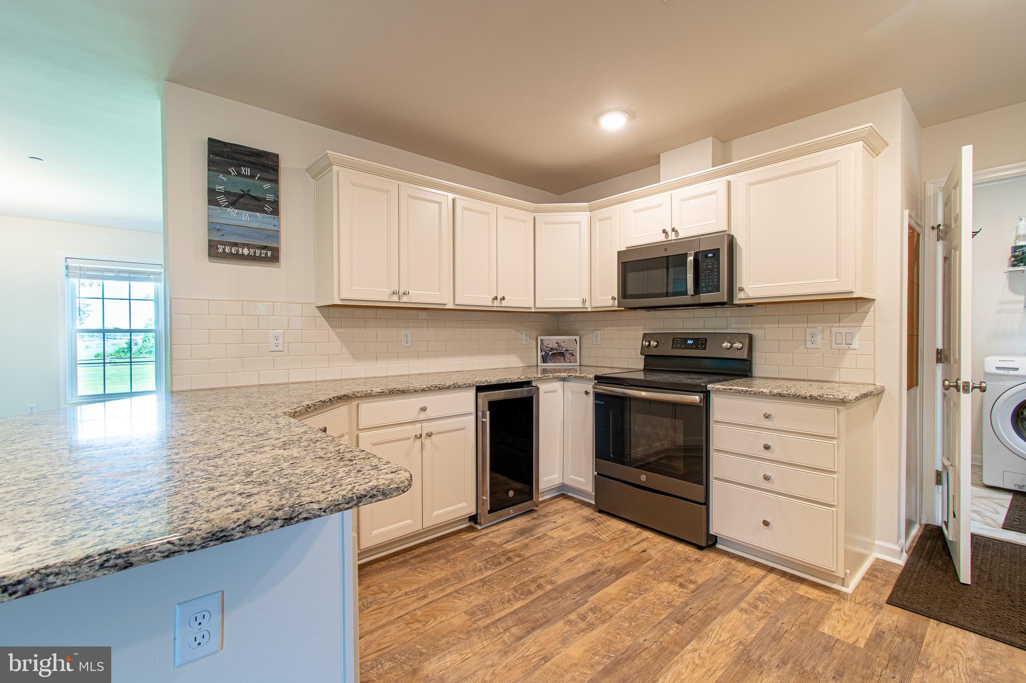 21869 Albie Road Sherwood, MD 21665 - Photo 10 of 38 a kitchen with granite countertop a sink cabinets stainless steel appliances and a counter space