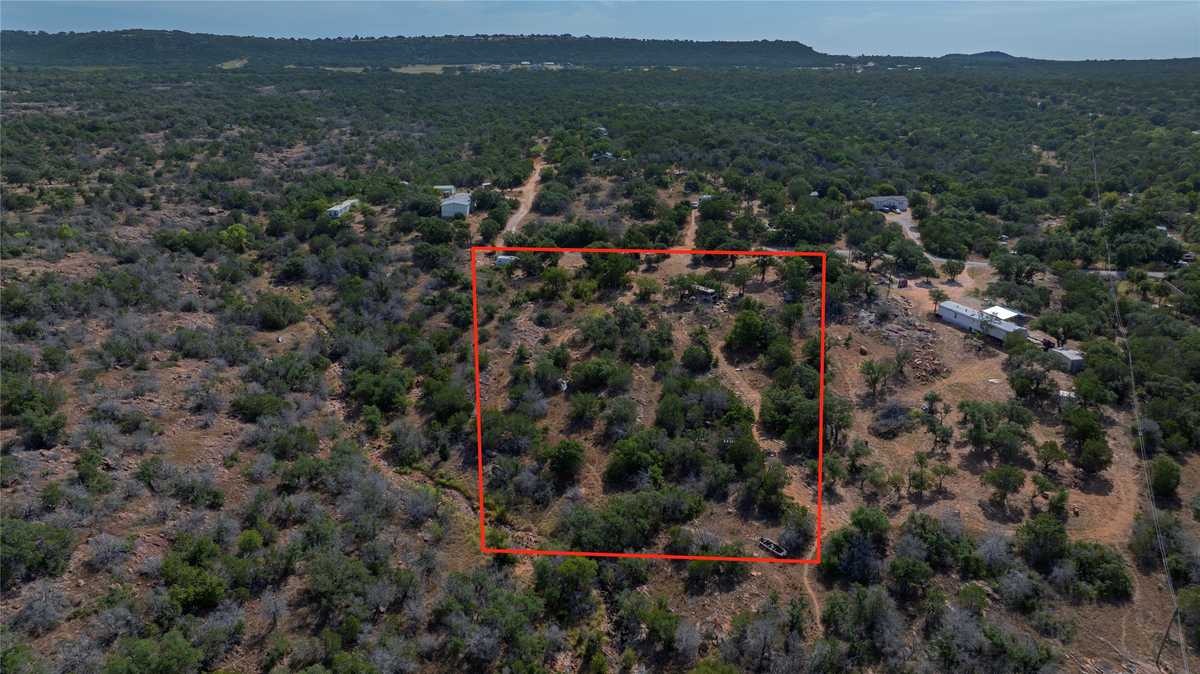 222 Valley Drive Burnet, TX 78611 - Photo 2 of 5 Dense native vegetation and rolling terrain define this expansive rural acreage surrounded by hill country vistas.