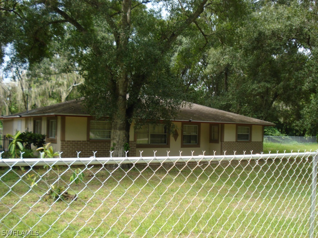 4549 Ballard Road Fort Myers, FL 33905 - Photo 1 of 4 a front view of a house with a yard