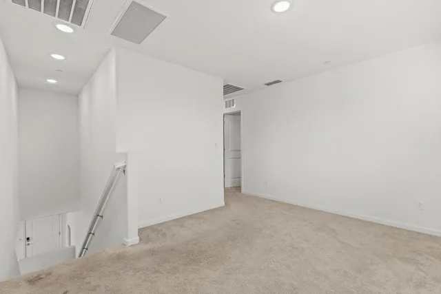 a spacious bedroom with a bed and window