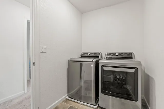 a bathroom with a granite countertop toilet sink and mirror