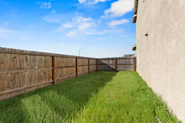 a view of backyard with garden and deck