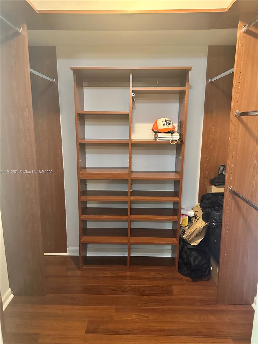 9156 Southwest 23rd Street, Unit D Davie, FL 33324 - Photo 13 of 14 a room with a wooden floor and a cabinet