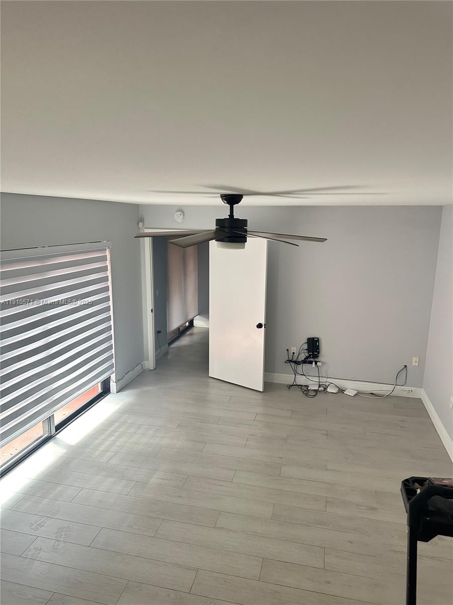 9156 Southwest 23rd Street, Unit D Davie, FL 33324 - Photo 7 of 14 a view of empty room with ceiling fan
